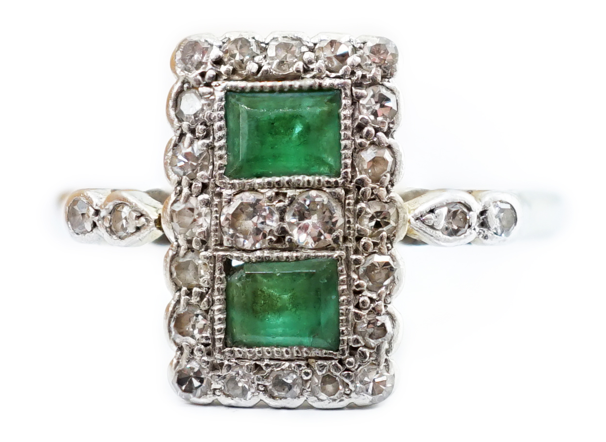 An Art Deco white metal, emerald and diamond set double cluster tablet ring, with diamond, set shoulders, size K, gross weight 2.6 grams.